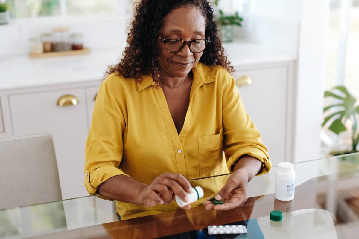 A woman is sorting her medicines