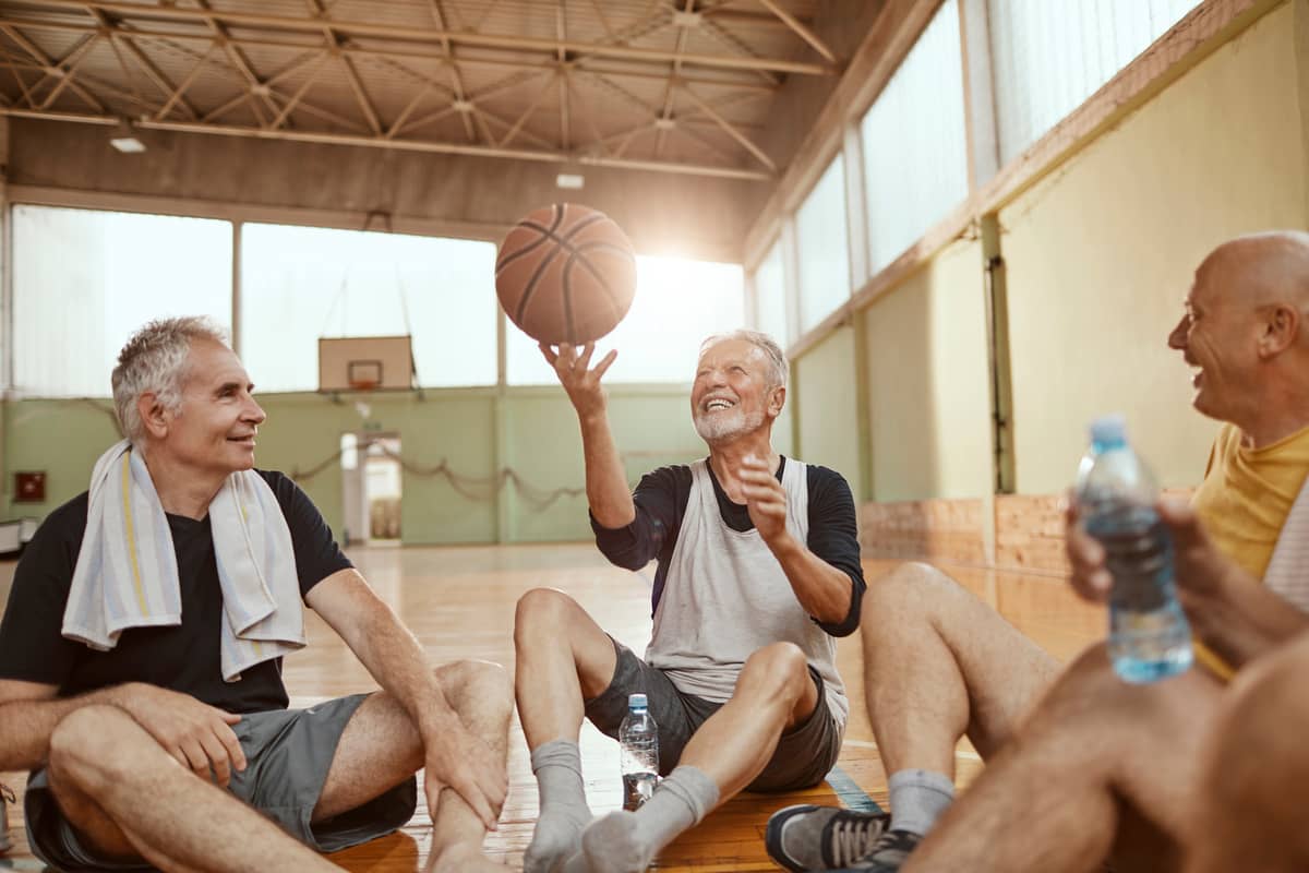 A group of senior men on a basketball court with a basketball