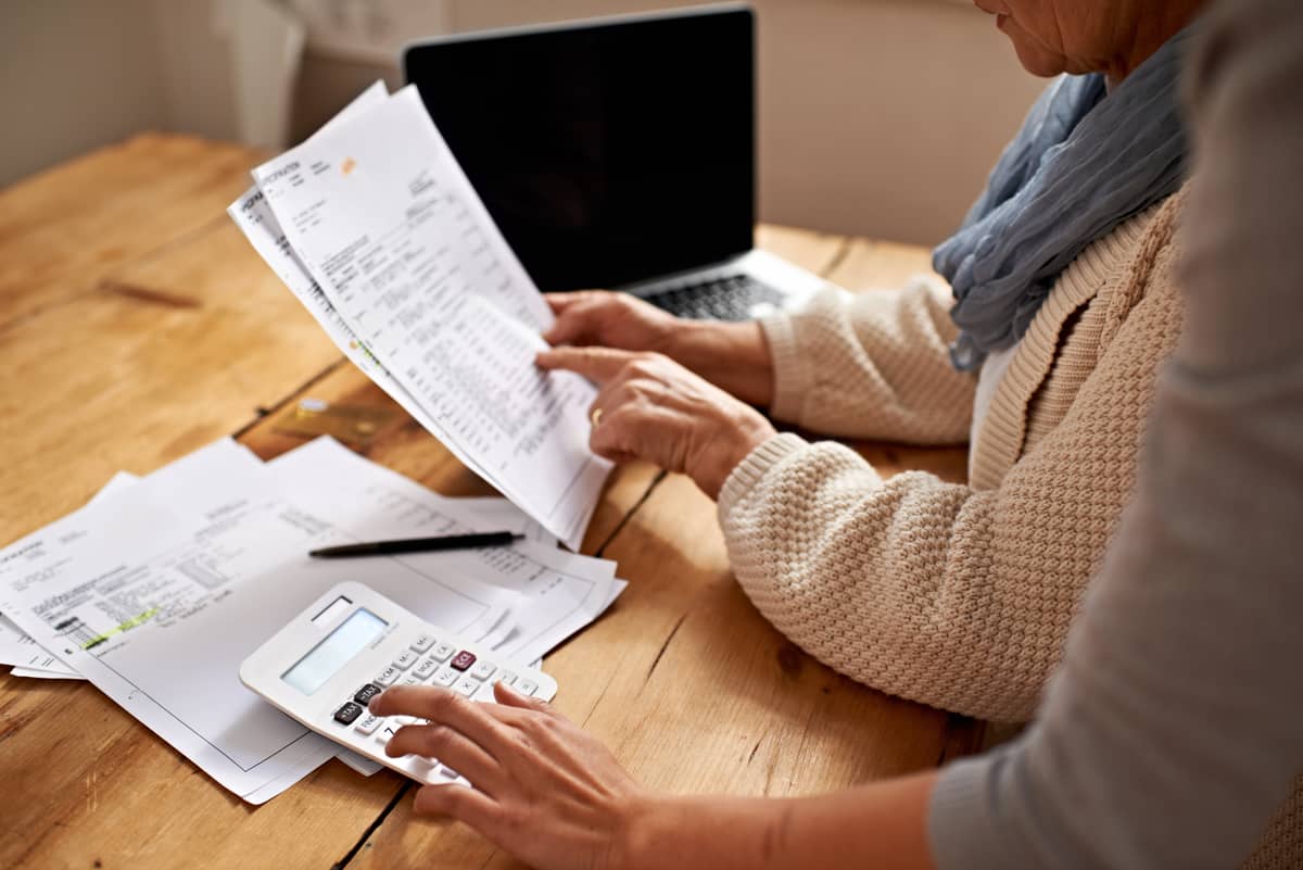 A senior woman and someone else going over finances together