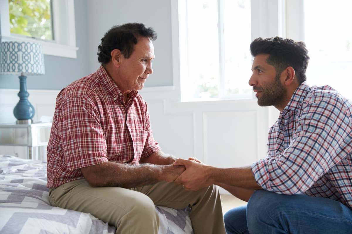 A man talking his senior father