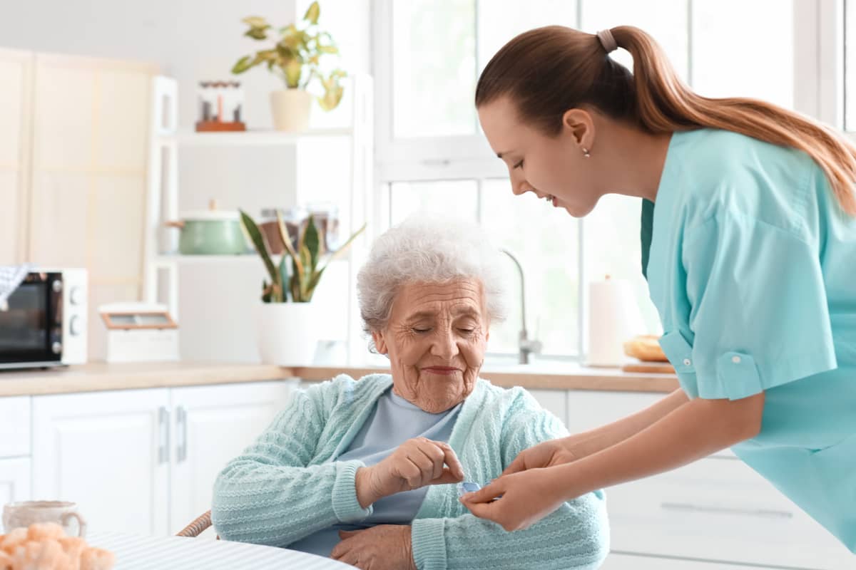 A caregiver giving a senior their medicine