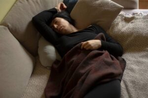 A woman on the couch looking exhausted