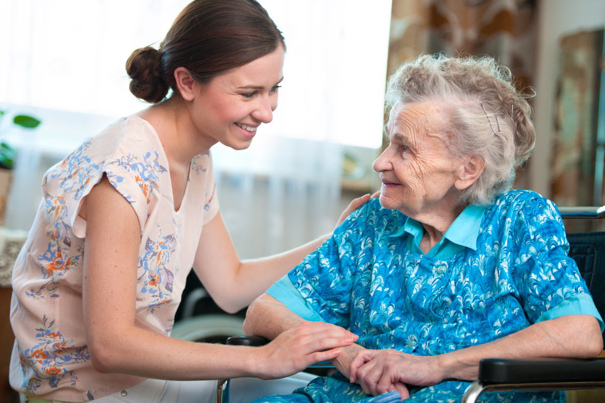 A caregiver helping a senior woman