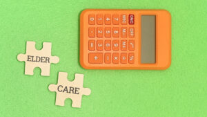 A calculator and puzzle pieces that say "Elder Care"