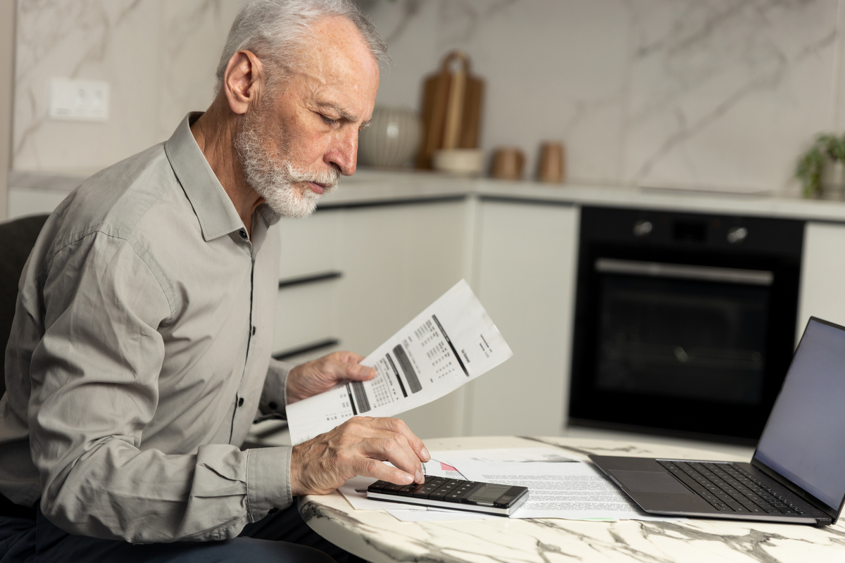 Senior man looking at pricing and bills