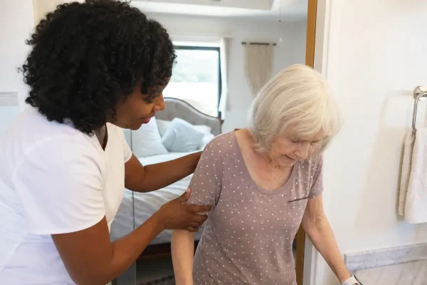 Home caregiver assisting elderly woman with morning routine in Santa Cruz California